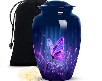 May include: A navy blue cremation urn with a butterfly design. The urn features a vibrant purple butterfly set against a backdrop of blue and purple hues. A black velvet bag and a white rose are also present.