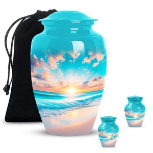 Beach memorial urn set featuring sunrise seascape artwork, includes one large and two small urns