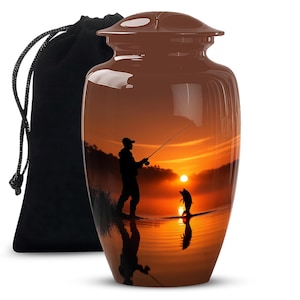 May include: Brown urn with a fishing scene at sunset. The urn features a silhouette of a person fishing and a fish jumping out of the water, set against a vibrant orange and yellow sky. A black velvet bag is on the left.