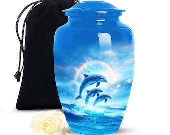 May include: A blue cremation urn with a glossy finish, featuring a vibrant scene of dolphins leaping from ocean waves under a rainbow. Includes a black velvet bag and a white rose.