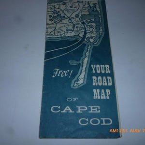 May include: A vintage road map of Cape Cod, featuring a detailed map illustration in blue and white. The cover reads "Free! Your Road Map of Cape Cod" in white text. The map is folded.