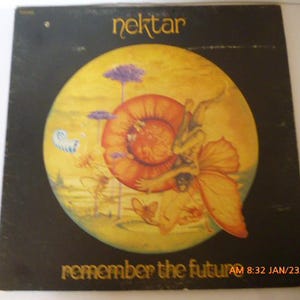 May include: A vintage vinyl record album cover featuring a psychedelic illustration of a winged creature with a large orange shell. The album is titled "Nektar" and the album title is "Remember the Future".