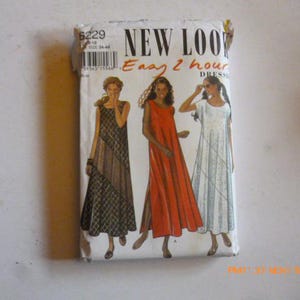 May include: A vintage New Look sewing pattern packet featuring illustrations of three different dresses. The packet has the text "Easy 2 hour dress" and the number 6229. The dresses are in shades of brown, red, and white.
