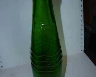 May include: A green glass bottle with a wavy design and the word "KRYPTON" embossed on the side.