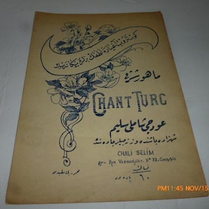 May include: Vintage sheet music cover with ornate floral and scroll designs in blue ink on aged paper. The title "CHANT TURC" is prominently displayed, with text in both French and another language. The cover includes the name "CHALI SELIM".