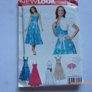 May include: A New Look sewing pattern package featuring illustrations of dresses. The package shows a blue floral dress with a matching white bolero jacket. Other dress designs include a red dress, a white dress, and a patterned dress. The package has the New Look logo.