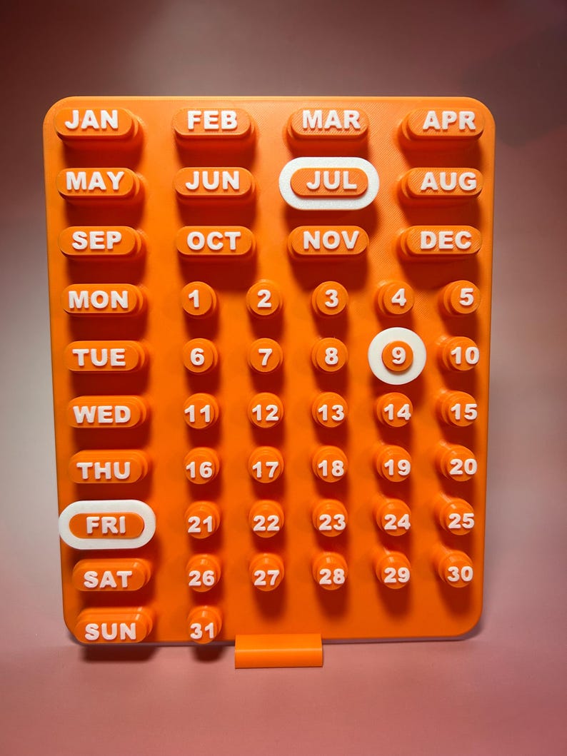 May include: Orange, modular calendar with white lettering and numbers. Months of the year are listed across the top, days of the week on the left, and dates in a grid. The current date is July 9th.
