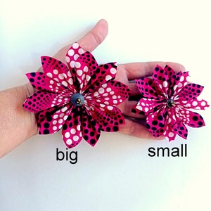 May include: Two fabric flowers with a pink and white polka dot pattern. The larger flower is labeled "big" and the smaller flower is labeled "small".