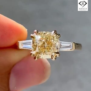 2.7 Carat Yellow Cushion Cut Moissanite Engagement Ring, Three Stone Tapered Baguette Setting, 14K Yellow Gold Vintage-Inspired Bridal Ring.