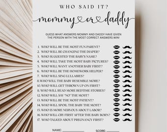 May include: A white baby shower game card with the text "Who Said It?" and "mommy or daddy" in elegant script. The game includes questions about the parents-to-be, with lip and mustache graphics. A fun activity for guests.