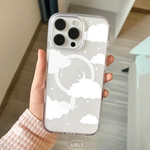 May include: Clear phone case with a white cloud and star design. The case has a circular design with a crescent moon. The brand name "UBLS" is printed at the bottom of the case.
