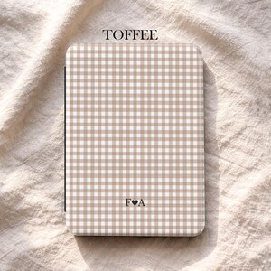 May include: A toffee-coloured notebook featuring a gingham pattern. The word "TOFFEE" is printed at the top, and the initials "F&hearts;A" are at the bottom. The brand name "UBLS" is printed at the bottom.