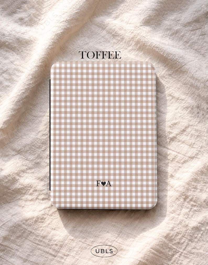 May include: A toffee-coloured notebook featuring a gingham pattern. The word "TOFFEE" is printed at the top, and the initials "F&hearts;A" are at the bottom. The brand name "UBLS" is printed at the bottom.