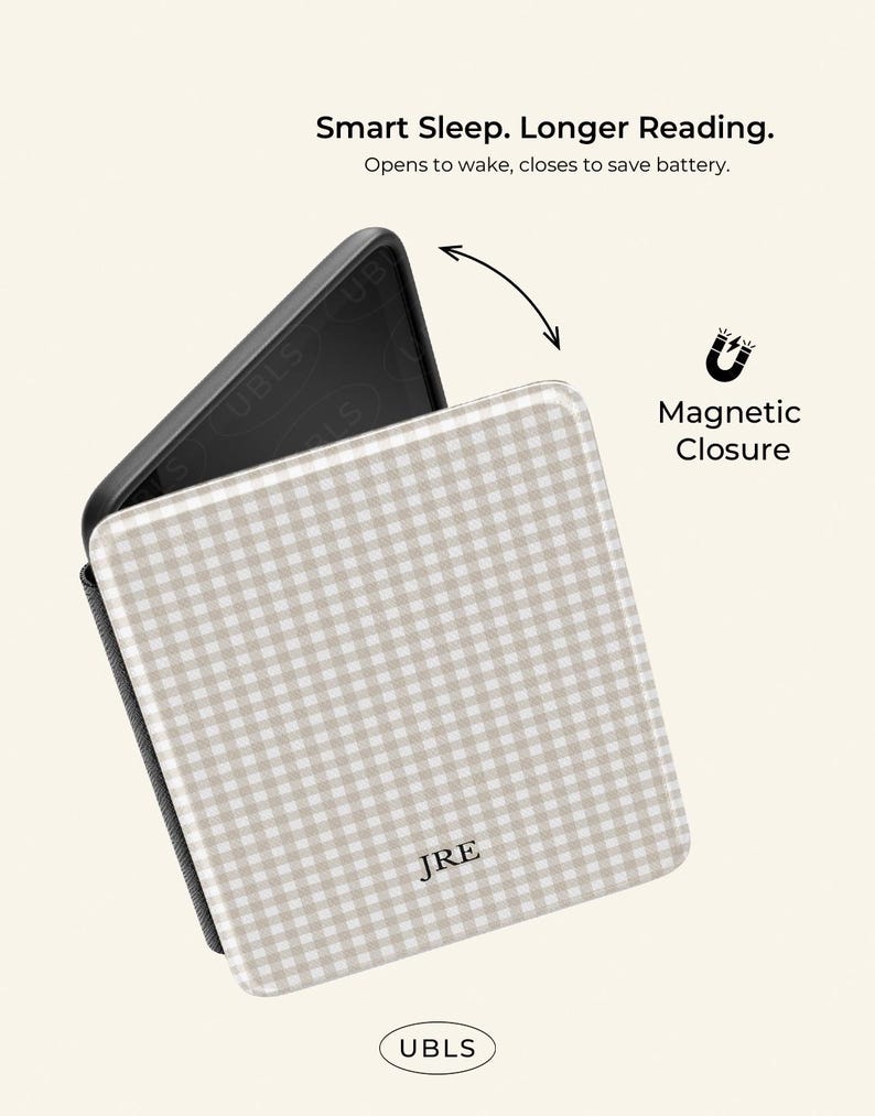 May include: A beige and white checked tablet case with the initials "JRE" on the front. The case has a magnetic closure and the text "Smart Sleep. Longer Reading." is displayed above the case.