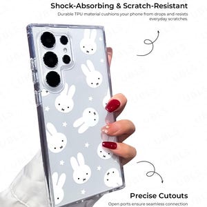 May include: Clear phone case with a white bunny and star pattern. The case is shock-absorbing and scratch-resistant, with precise cutouts for chargers, headphones, and speakers. The text on the case reads "Shock-Absorbing & Scratch-Resistant" and "Precise Cutouts".