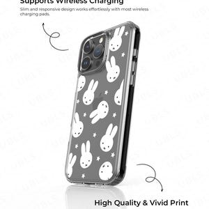 May include: Clear phone case with a gray background and a pattern of white bunny faces and stars. The case is designed to support wireless charging and features high-quality, vivid printing.