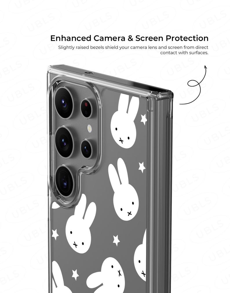 May include: Clear phone case with a gray background and white bunny and star pattern. The case has a protective design with slightly raised bezels to shield the camera lens and screen from contact with surfaces. Text on the case reads: Enhanced Camera & Screen Protection.