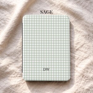 May include: A sage green and white gingham pattern case with the initials "DW". The word "SAGE" is printed at the top. The case is rectangular with rounded corners. The brand name "UBLS" is printed at the bottom.