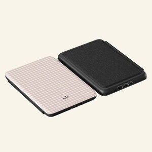 May include: Two phone cases. One case has a black textured surface. The other case has a pink and white gingham pattern with the initials "CB". The brand name "UBLS" is printed at the bottom.