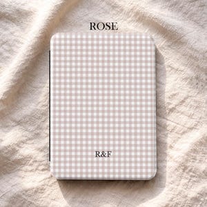 May include: A rectangular case featuring a beige and white gingham design. The word "ROSE" is printed at the top, with the initials "R&F" in the centre. The brand name "UBLS" is printed at the bottom.