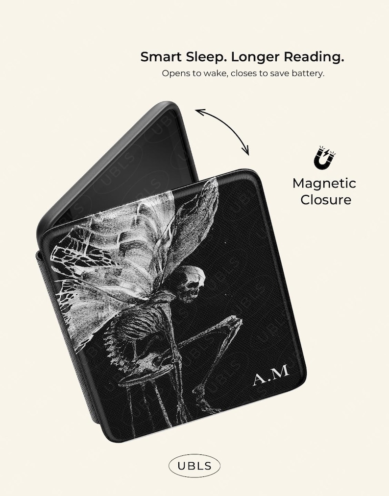May include: A black e-reader case with a magnetic closure, featuring a white skeletal fairy illustration and the initials A.M. Text reads: Smart Sleep. Longer Reading. Opens to wake, closes to save battery. Magnetic Closure. UBLS.