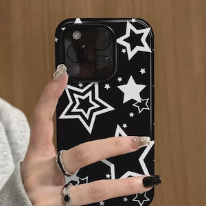 May include: Black phone case with a white star pattern. The case has a glossy finish and a rectangular shape. The camera lens is visible at the top. The brand name "UBLS" is printed at the bottom.