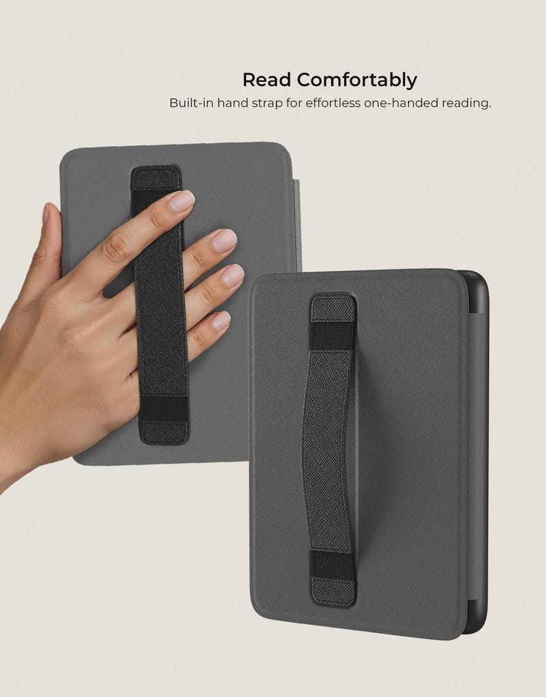 May include: Two grey e-reader cases with built-in black hand straps are shown. One case is held by a hand, demonstrating the strap's use. The text "Read Comfortably" and "Built-in hand strap for effortless one-handed reading" are visible.