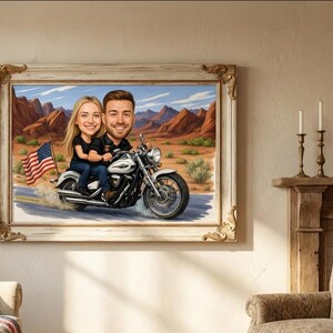 Framed artwork depicting a couple riding a motorcycle through a desert landscape. The artwork features a caricature style with the American flag waving in the background. The frame is ornate with gold accents.