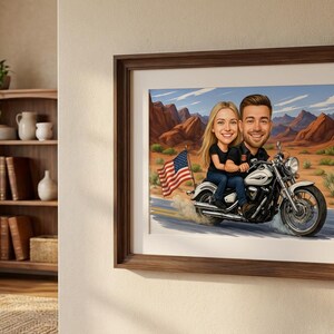 Framed artwork featuring a cartoon couple riding a white motorcycle with an American flag waving behind them. The background depicts a desert landscape with red rock formations and a blue sky.