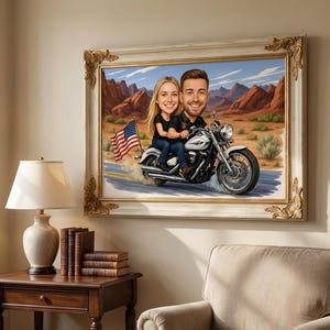 A framed painting depicts a couple riding a motorcycle through a desert landscape. The motorcycle is white and silver, and the American flag waves in the background. The frame has a gold ornate design.