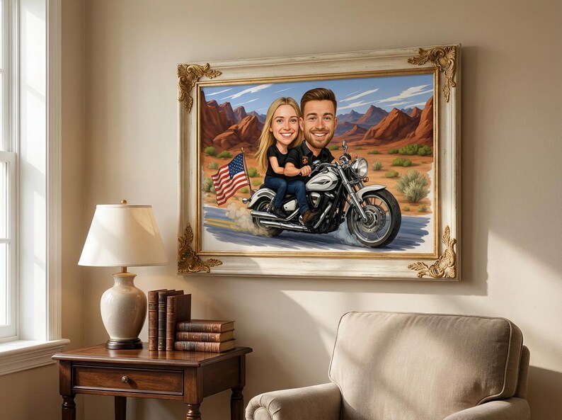 A framed painting depicts a couple riding a motorcycle through a desert landscape. The motorcycle is white and silver, and the American flag waves in the background. The frame has a gold ornate design.