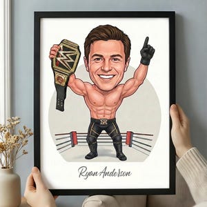 May include: A framed caricature print of a wrestler holding a championship belt and raising one arm. The wrestler is muscular and wearing black and gold wrestling attire. The print includes the name "Ryan Anderson" at the bottom.