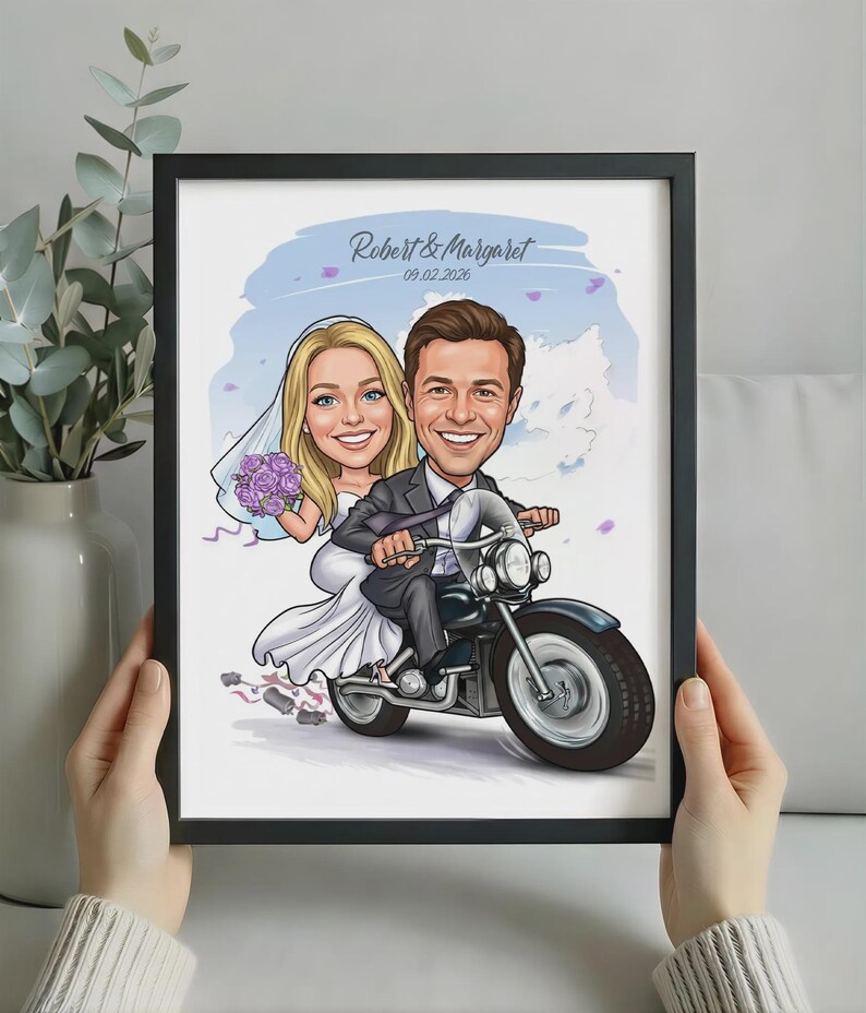 May include: A framed caricature illustration of a bride and groom riding a motorcycle. The bride wears a white dress and veil, holding purple flowers. The groom wears a dark suit. Text reads Robert & Margaret and 09.02.2026.
