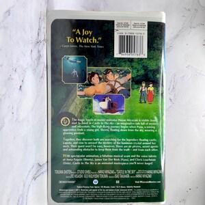 May include: The back of a VHS tape for the animated film "Castle in the Sky." The cover displays colourful illustrations of characters and scenes from the movie, with text including the title and a quote from The New York Times.