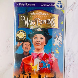 May include: A VHS tape of Walt Disney's Masterpiece "Mary Poppins." The cover features a vibrant illustration of the film's characters, including Mary Poppins, and the text "Fully Restored" and "Limited Edition."