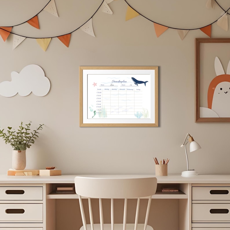 May include: A framed wall art piece with a light wood frame. The artwork features a schedule with a whale illustration and the text "Stundenplan". Decorative elements include a starfish, seahorse, and aquatic plants. The background is a neutral beige.