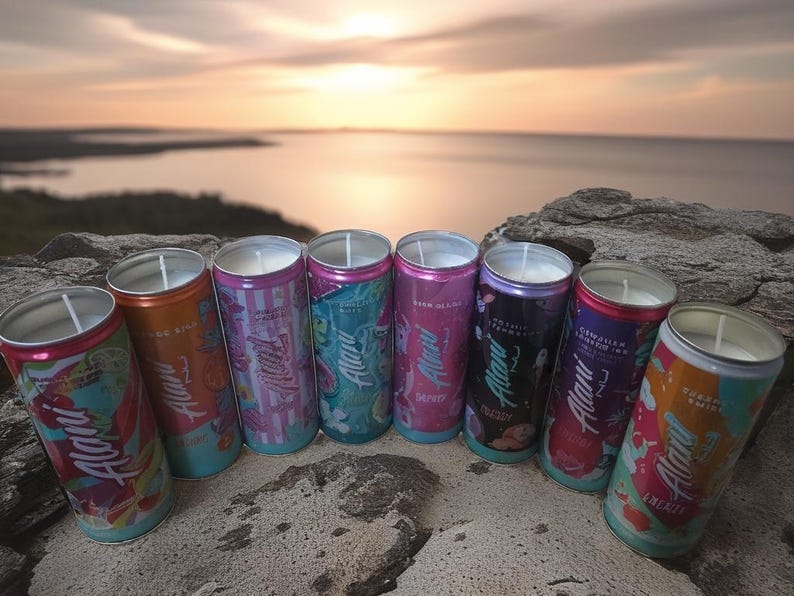 May include: Eight brightly coloured candles in aluminium cans, each with a white wax top and a wick. The cans display various designs and the word "Alani". The background shows a sunset over a body of water.