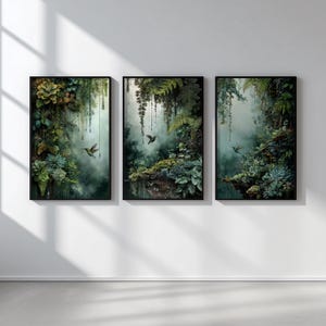 May include: Three framed art prints featuring a lush, green jungle scene with a misty background. Each print showcases a different section of the jungle, with ferns, succulents, and hummingbirds. The artwork is framed in black.