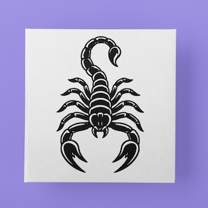 May include: Black scorpion illustration on a white square against a purple background. The scorpion is depicted in a detailed, stylized design, with its tail curved upwards. The image is a graphic representation, suitable for various applications.