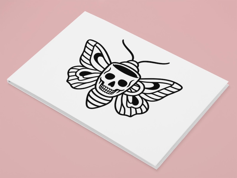 May include: A white card featuring a black illustration of a moth with a skull design. The moth's wings and body are detailed with black lines, creating a striking contrast against the white background. The card is set against a pink backdrop.