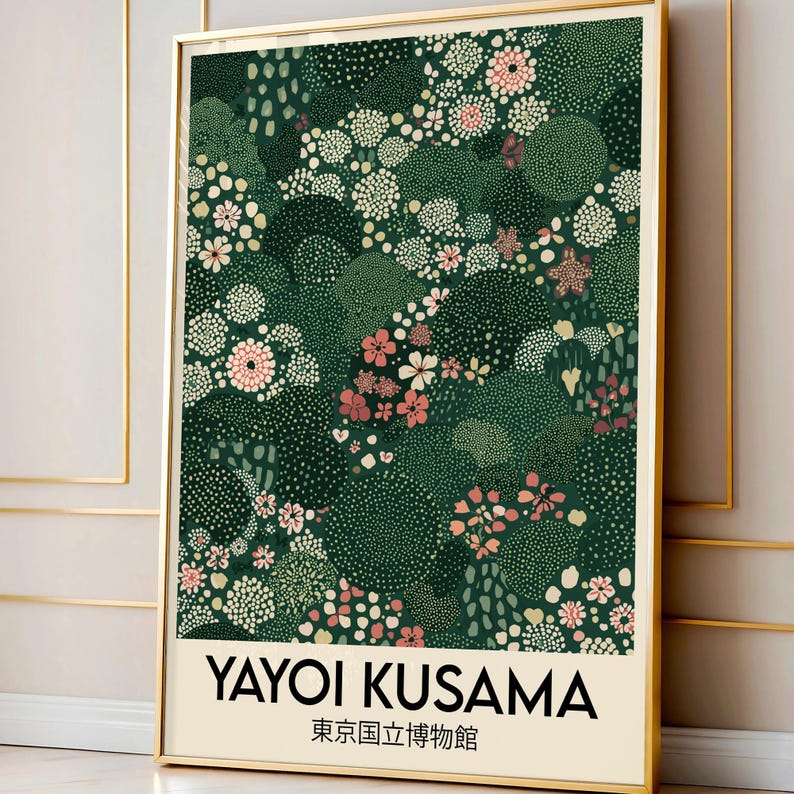 May include: A framed art print featuring a floral pattern in shades of green, pink, and white. The print includes the text "YAYOI KUSAMA" and Japanese characters. The artwork is displayed in a gold frame.