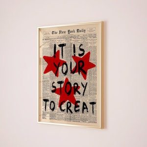 May include: Framed artwork featuring a vintage newspaper background with the headline "The New York Daily." Bold black text and red star shapes read "IT IS YOUR STORY TO CREATE."