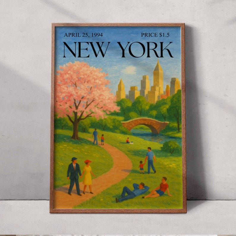 May include: A framed print featuring a park scene in New York City. The artwork depicts a cherry blossom tree, a stone bridge, and a skyline. The text "APRIL 25, 1994" and "NEW YORK" are visible. The print is in a wooden frame.