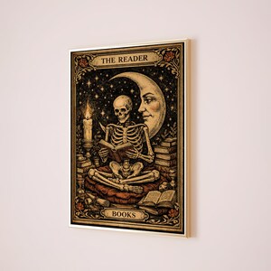 May include: Framed artwork featuring a skeleton reading a book, with a crescent moon and stars in the background. The words "THE READER" and "BOOKS" are displayed. A lit candle and stacks of books are also visible.