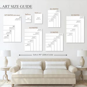 May include: Wall art size guide showing different aspect ratios and dimensions, including 12x16 cm, 28x36 cm, and 61x76 cm sizes. The guide is displayed above a beige sofa that is 228 cm wide, with two lamps on either side.