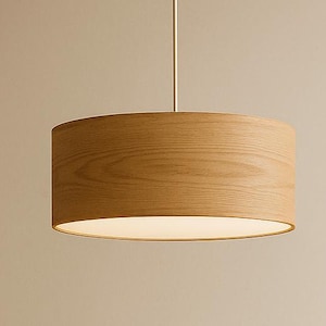 May include: A dining room set featuring a round wooden table and matching chairs. A wooden pendant light hangs above the table. A vase with greenery and a bowl are on the table. The chairs have woven seats.