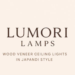 May include: The text "LUMORI LAMPS" in a dark brown font is displayed at the top of the image. Below, the text "WOOD VENEER CEILING LIGHTS IN JAPANDI STYLE" is displayed in a smaller, dark brown font. The background is a light beige color.