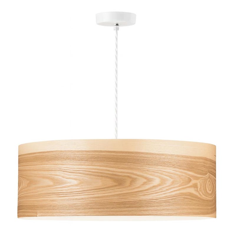 May include: A modern pendant light fixture with a cylindrical lampshade made of light-colored wood grain. The fixture is suspended from a white ceiling mount by a white cord. The lampshade has a warm, natural wood tone.