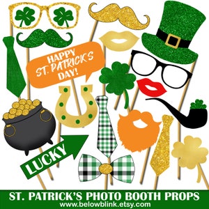 May include: A collection of St. Patrick's Day photo booth props on wooden sticks. Includes green glitter shamrock glasses, mustaches, hats, ties, and a speech bubble with "Happy St. Patrick's Day!" text. Also features a pot of gold and a horseshoe.
