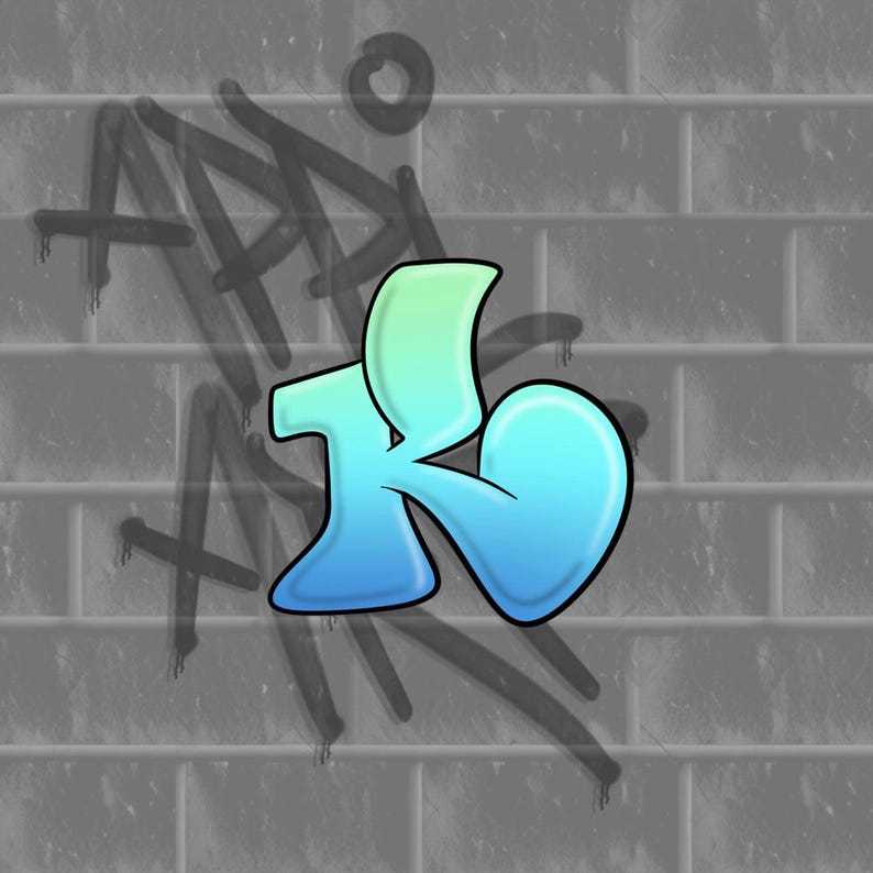 May include: A graffiti-style letter "K" in shades of blue and green, outlined in black, against a gray brick wall. Faint black graffiti art is in the background, adding to the urban aesthetic.